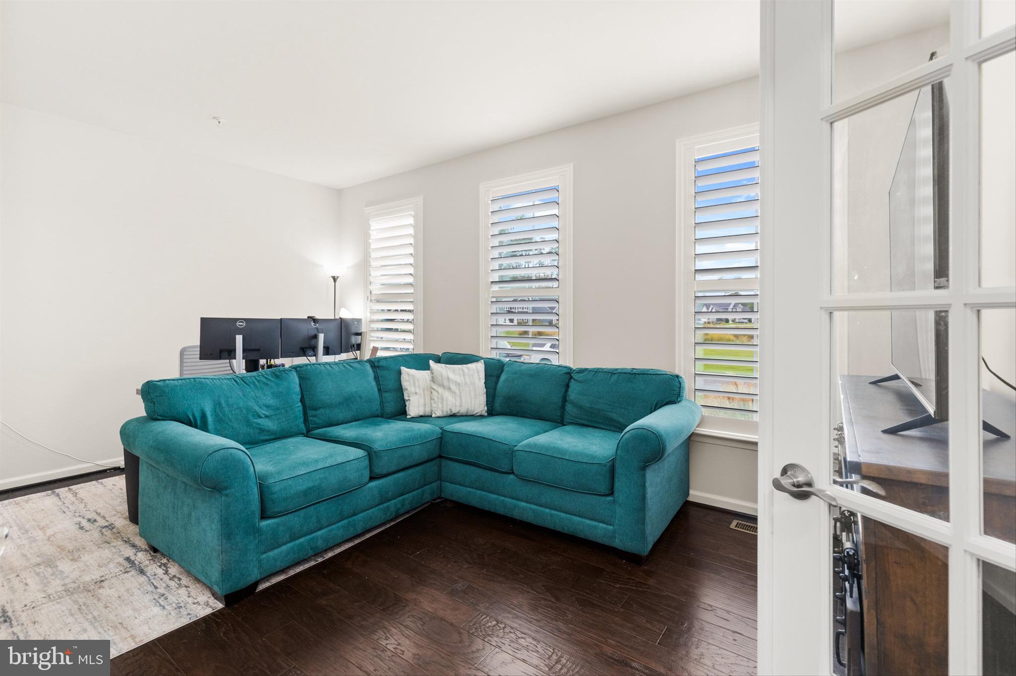 10135 Fast Colors Lane Berlin, MD 21811 - Photo 19 of 63 a living room with furniture and a large window