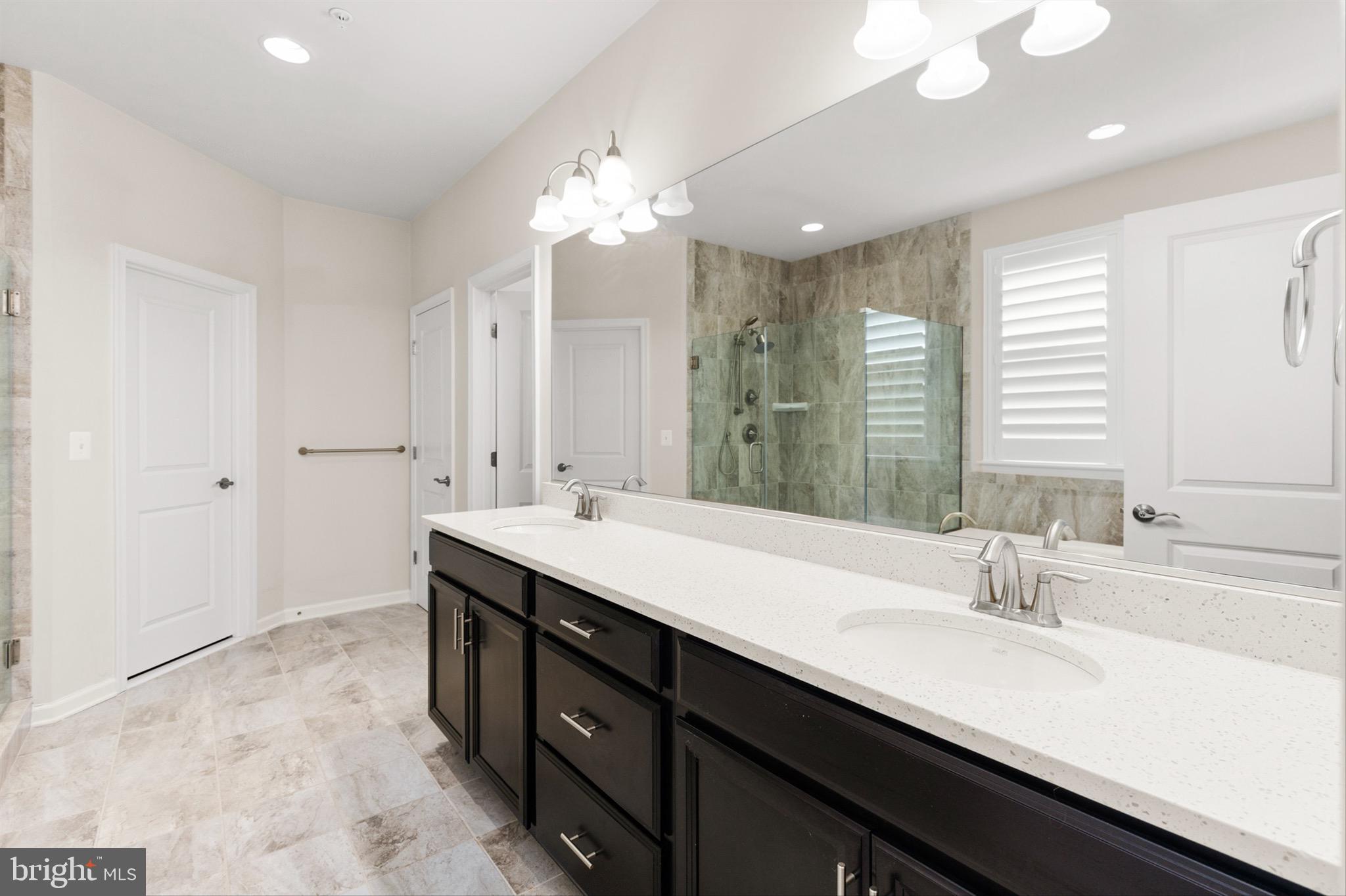 10135 Fast Colors Lane Berlin, MD 21811 - Photo 25 of 63 a bathroom with double vanity sinks and a mirror