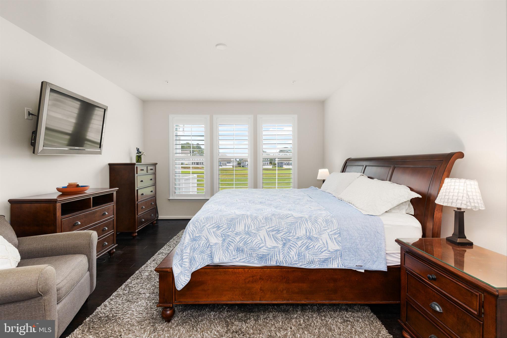 10135 Fast Colors Lane Berlin, MD 21811 - Photo 28 of 63 a bedroom with a bed a couch and a flat screen tv