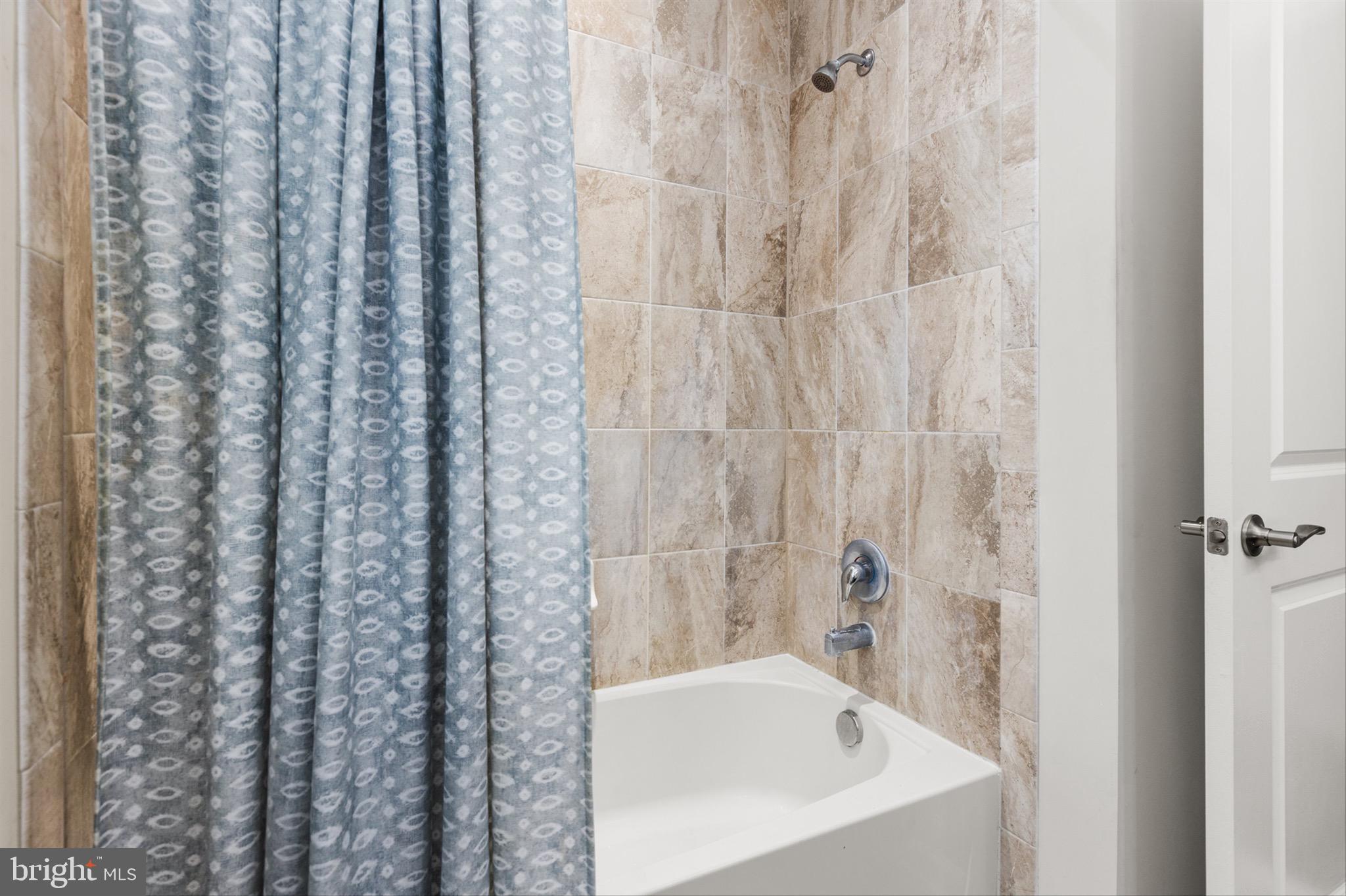 10135 Fast Colors Lane Berlin, MD 21811 - Photo 33 of 63 a bathroom with a bathtub and shower