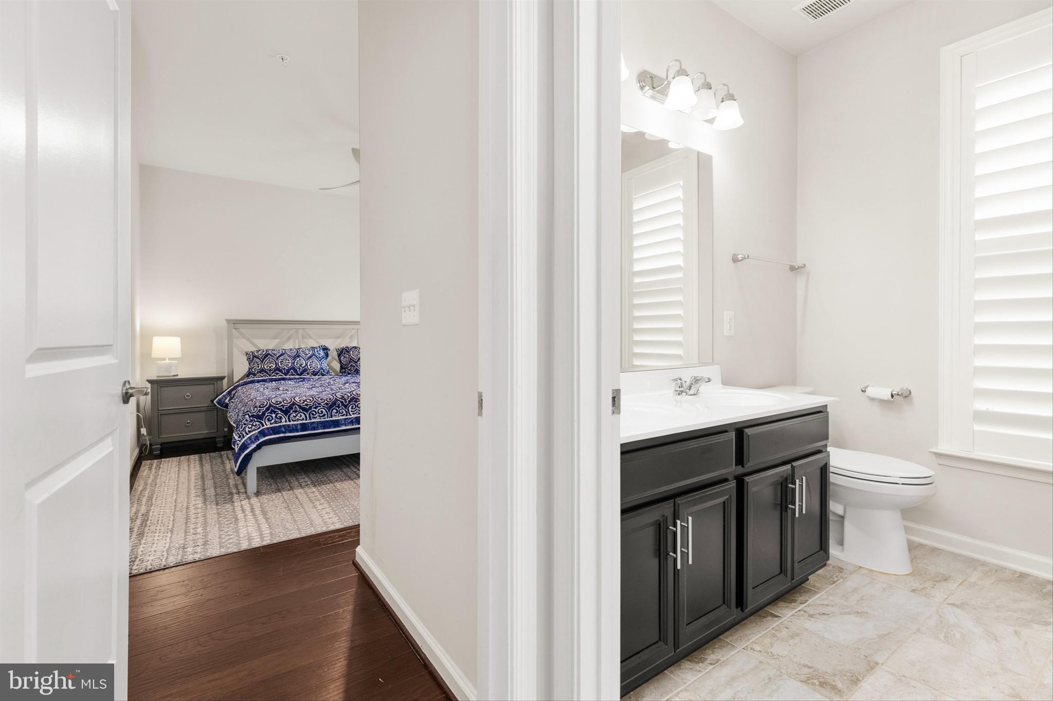 10135 Fast Colors Lane Berlin, MD 21811 - Photo 34 of 63 a en suite bathroom with a toilet sink and mirror