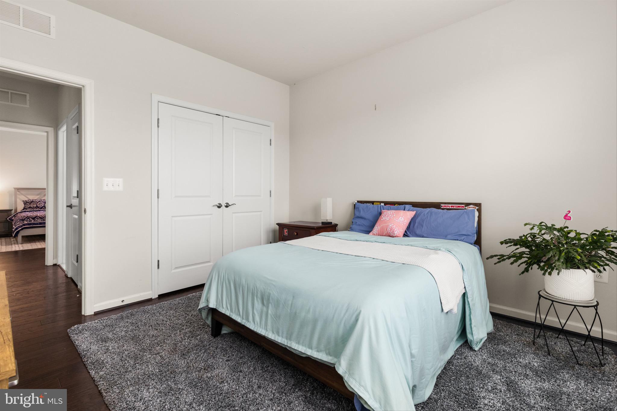 10135 Fast Colors Lane Berlin, MD 21811 - Photo 36 of 63 a bedroom with a bed and wooden floor