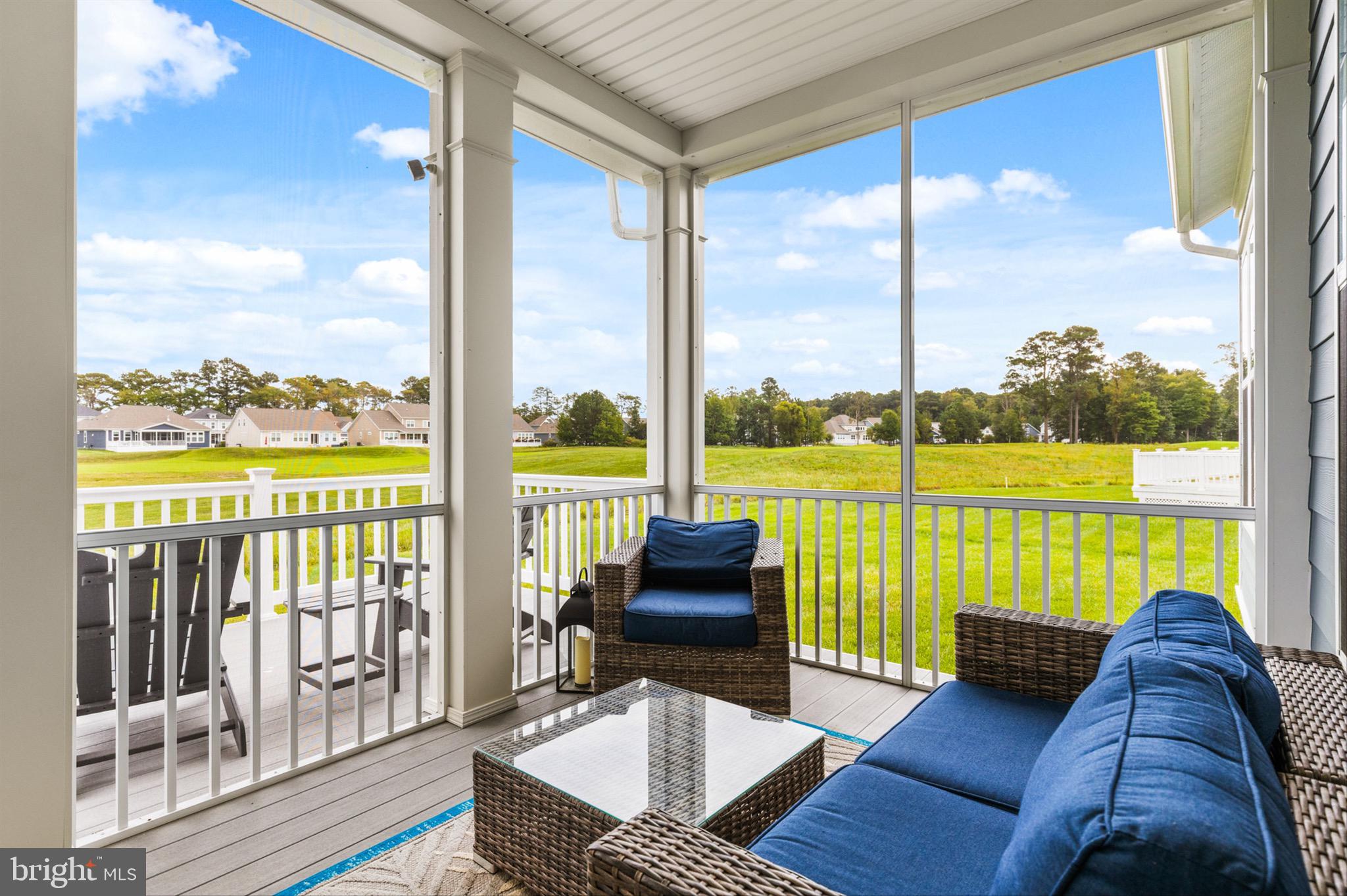 10135 Fast Colors Lane Berlin, MD 21811 - Photo 41 of 63 a living room with furniture tv and a floor to ceiling window