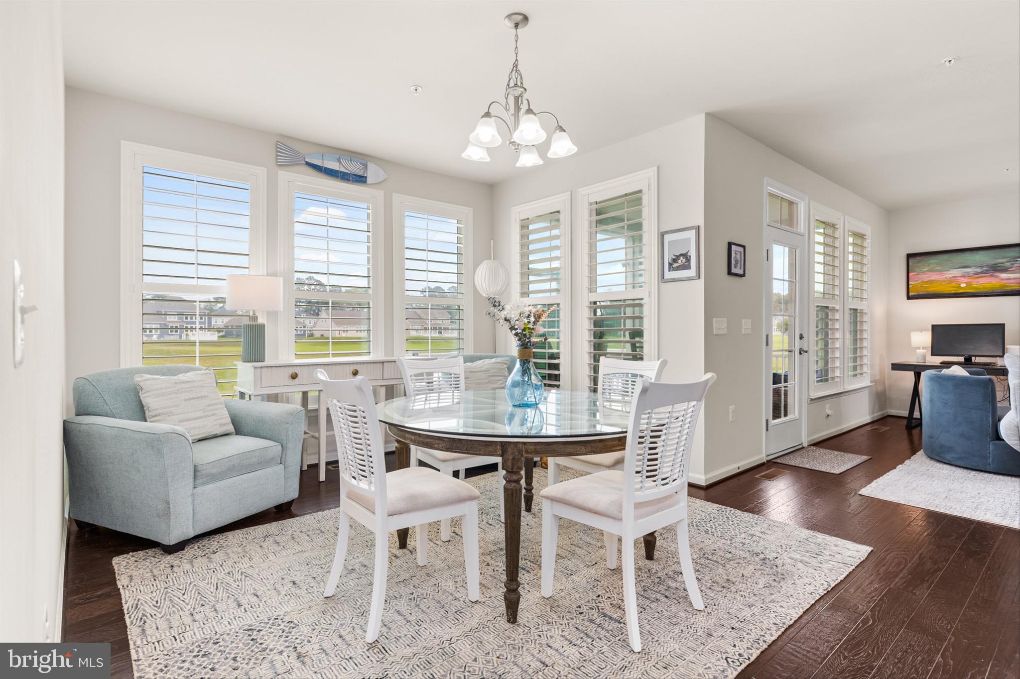 10135 Fast Colors Lane Berlin, MD 21811 - Photo 6 of 63 a view of a dining room with furniture and wooden floor