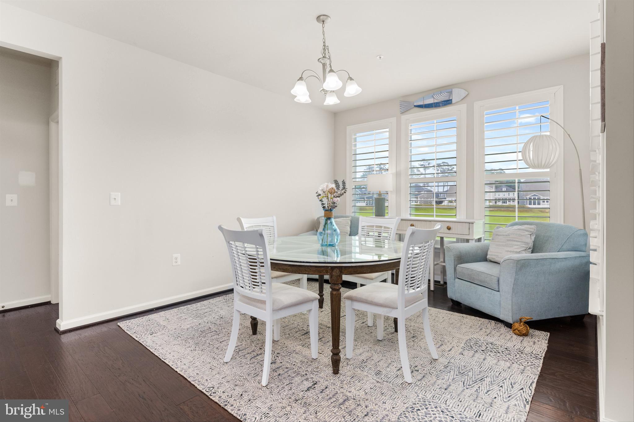 10135 Fast Colors Lane Berlin, MD 21811 - Photo 8 of 63 a view of a dining room with furniture and wooden floor