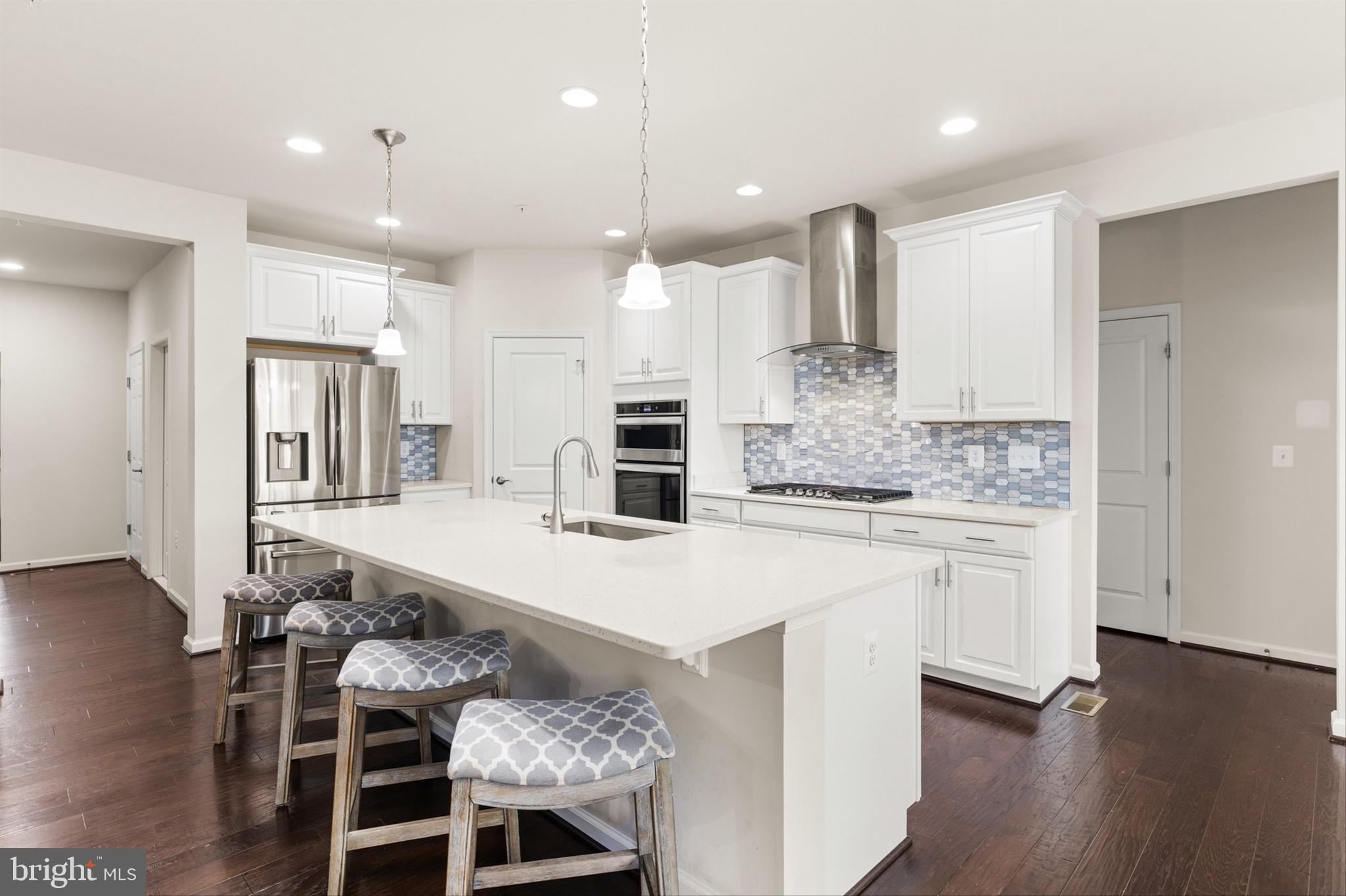 10135 Fast Colors Lane Berlin, MD 21811 - Photo 10 of 63 a large kitchen with a table and chairs