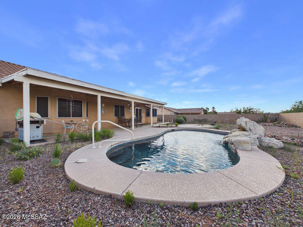 6827 South Star Ridge Place Tucson, AZ 85757 - Photo 22 of 28 a view of a house with roof porch and sitting area