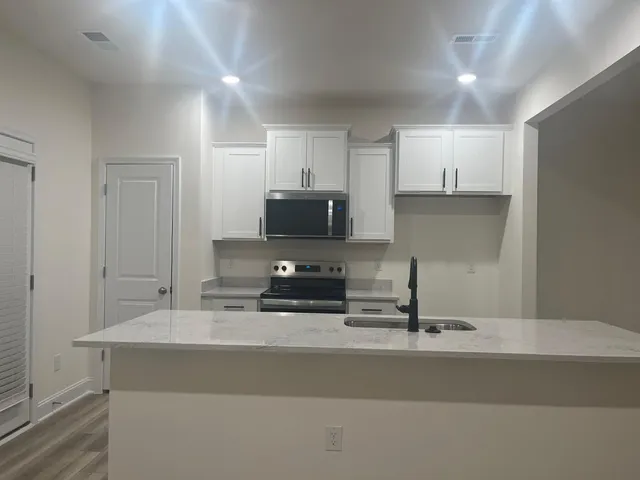 a kitchen with a sink stainless steel appliances and cabinets