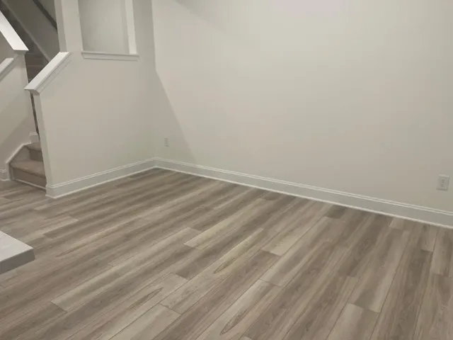 a view of a room with wooden floor