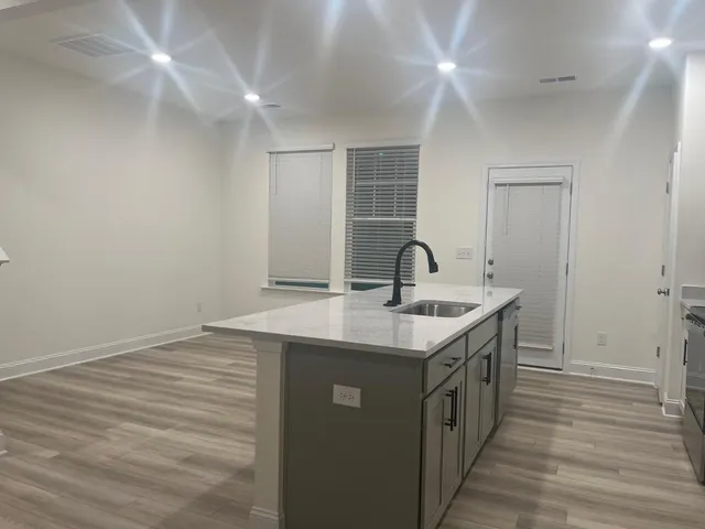 a kitchen with a sink and a mirror