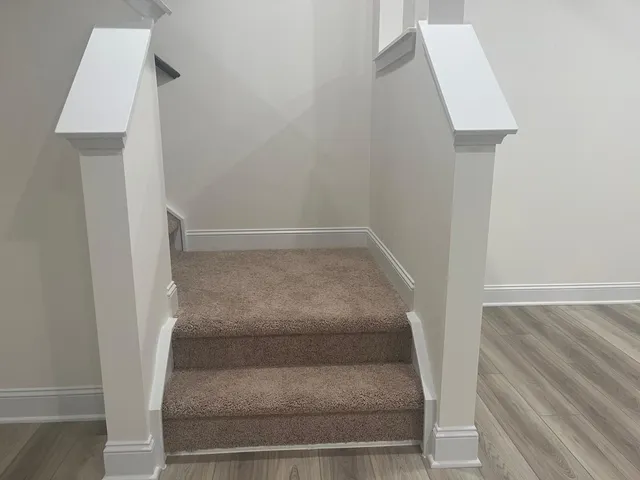 a view of staircase with white walls