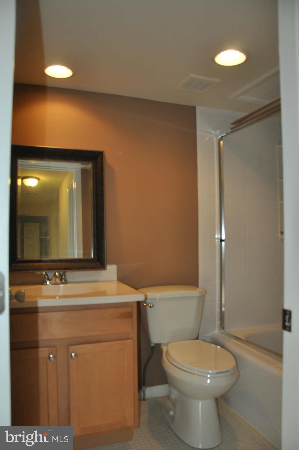 9415 Merryrest Road Columbia, MD 21045 - Photo 10 of 17 a bathroom with a toilet sink and mirror