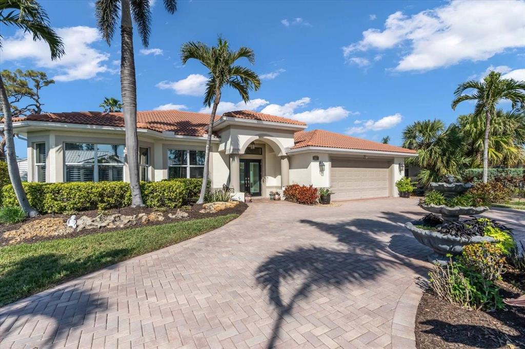 612 Cadiz Road Venice, FL 34285 - Photo 1 of 1 a front view of a house with a yard and potted plants