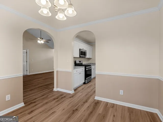 a kitchen with a refrigerator and a stove top oven