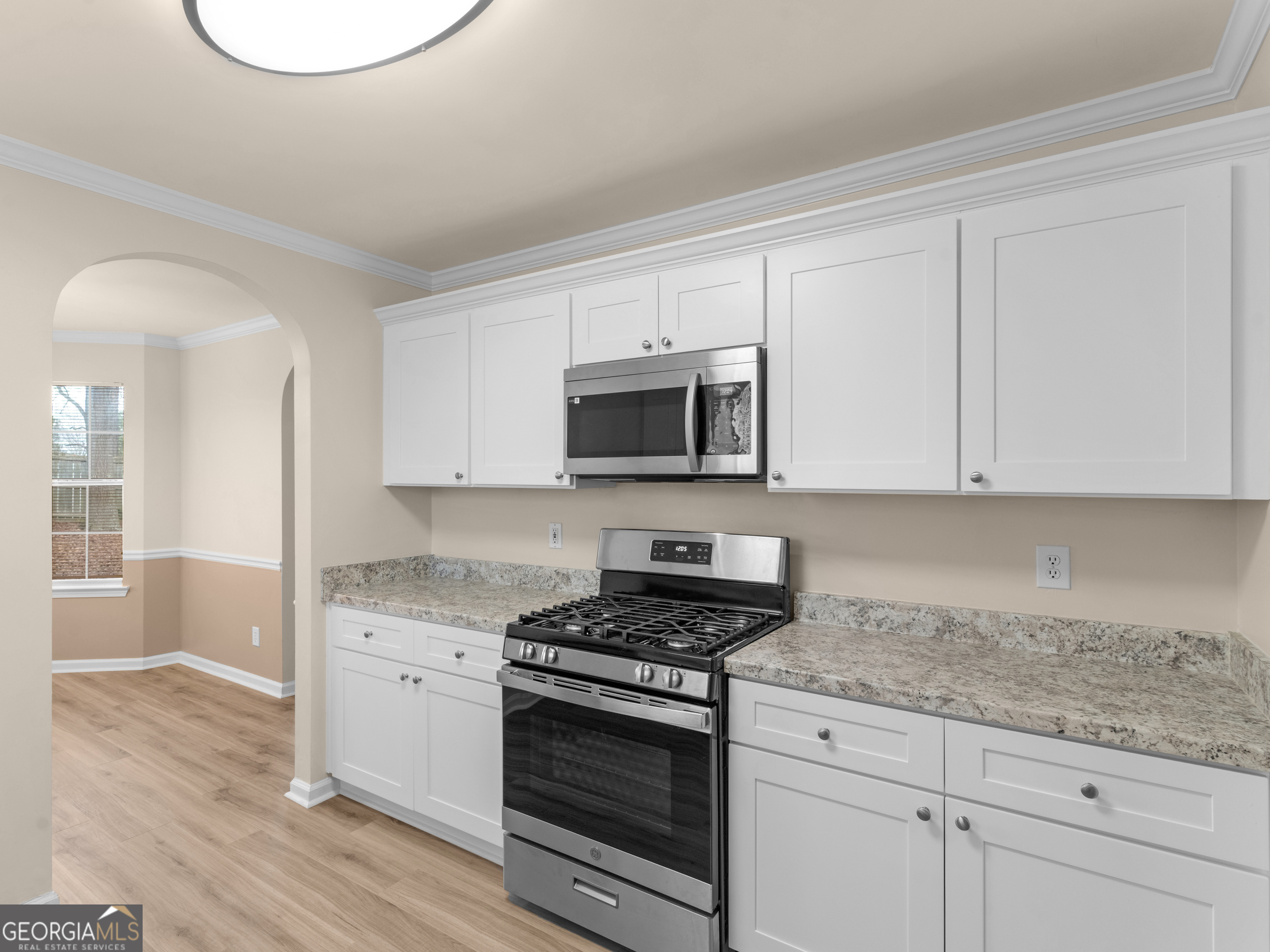 729 Old Stone Court Stockbridge, GA 30281 - Photo 15 of 47 a kitchen with granite countertop white cabinets and stainless steel appliances