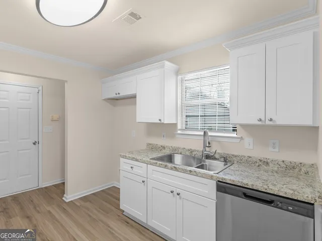 a kitchen with a sink cabinets and window