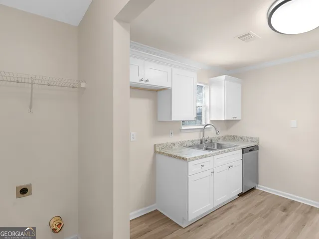 a kitchen with a sink and a mirror