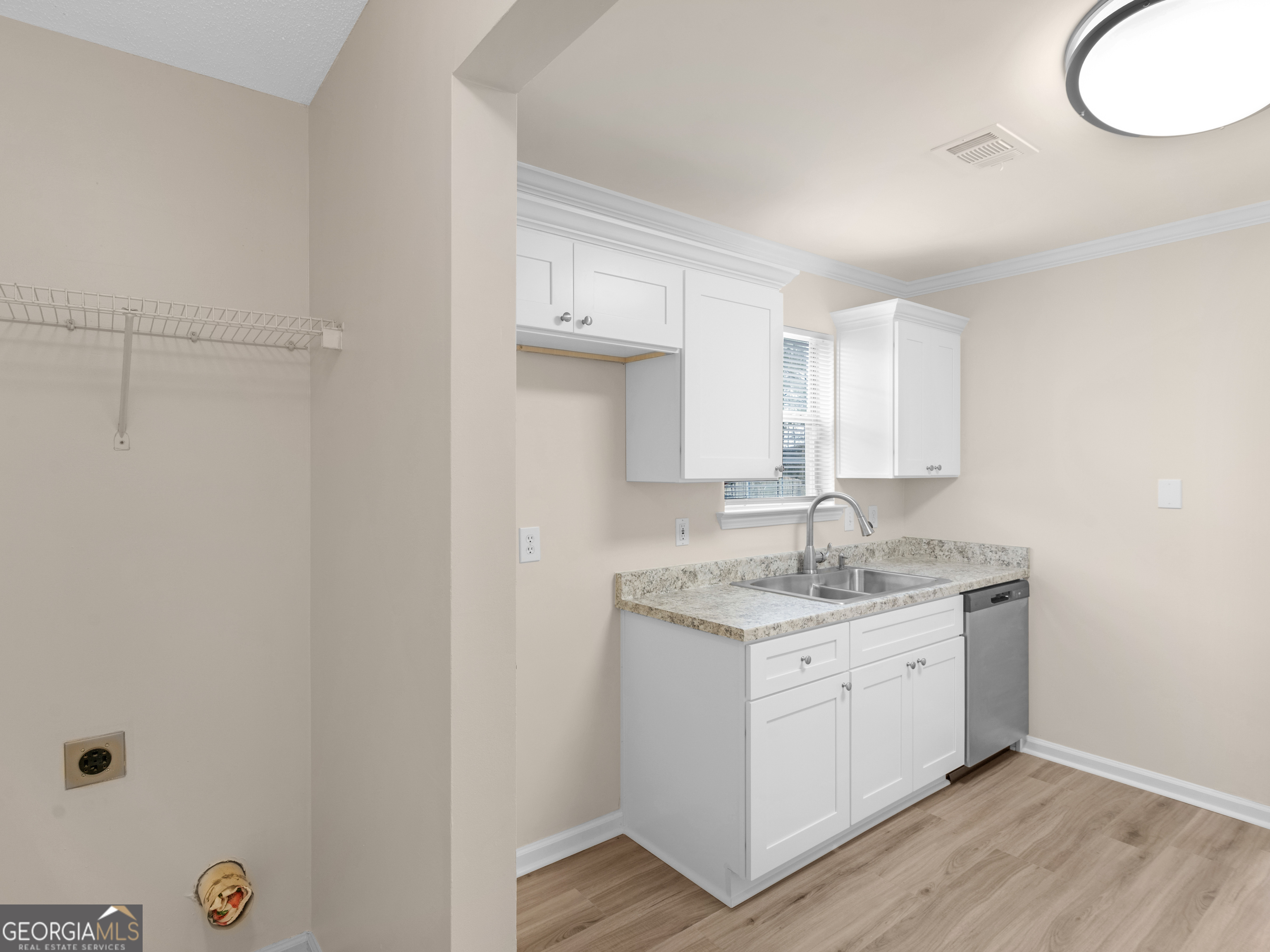 729 Old Stone Court Stockbridge, GA 30281 - Photo 18 of 47 a kitchen with a sink and a mirror