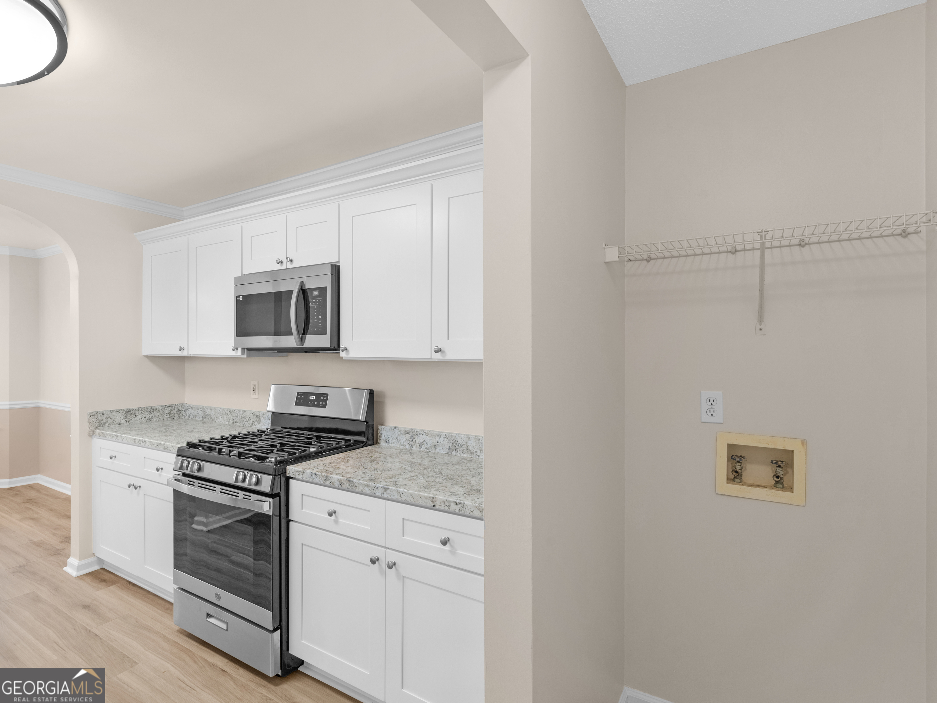 729 Old Stone Court Stockbridge, GA 30281 - Photo 19 of 47 a kitchen with granite countertop white cabinets and stainless steel appliances