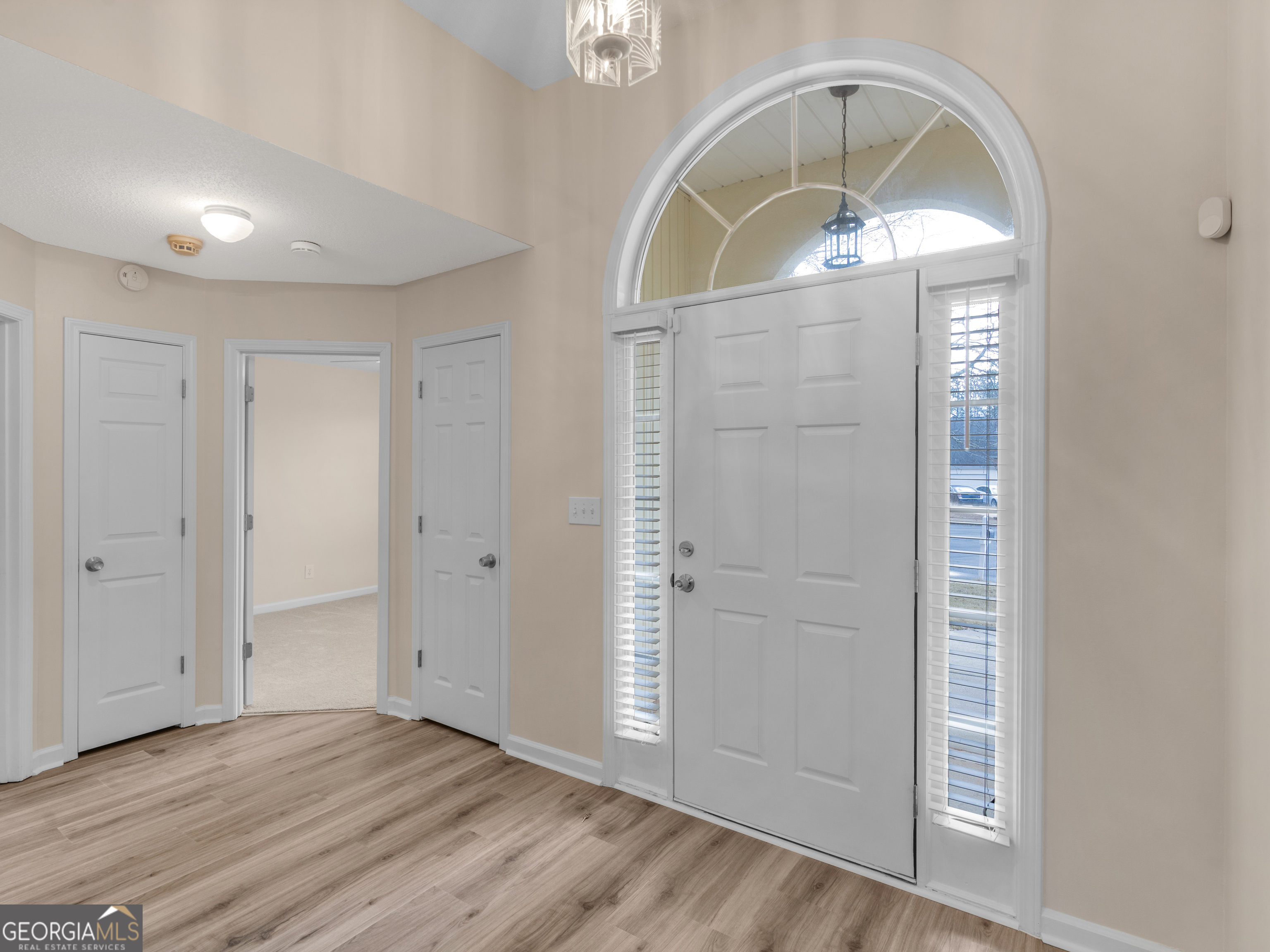 729 Old Stone Court Stockbridge, GA 30281 - Photo 2 of 47 an empty room with wooden floor mirror and windows