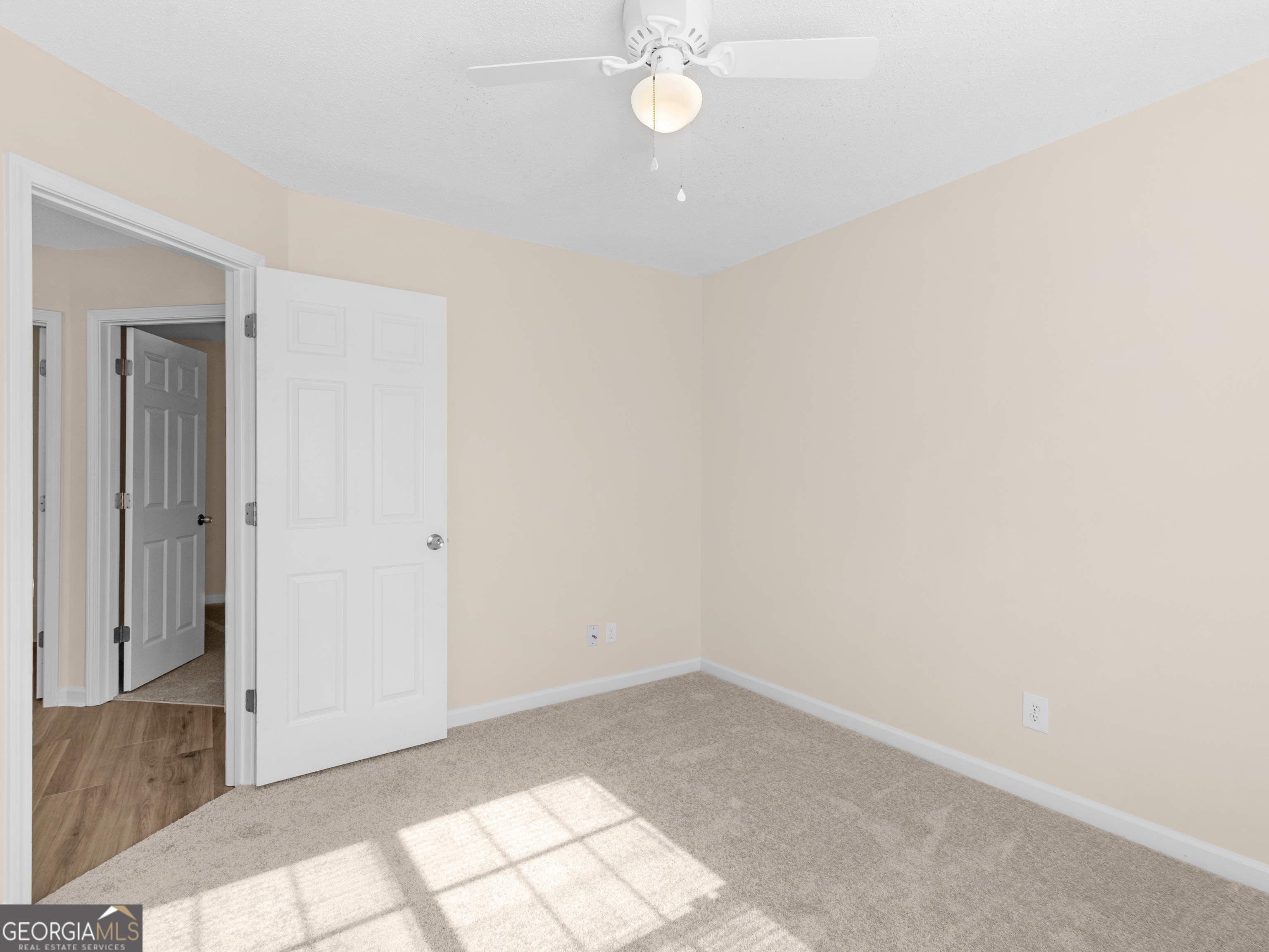 729 Old Stone Court Stockbridge, GA 30281 - Photo 30 of 47 an empty room with a chandelier fan and glass door