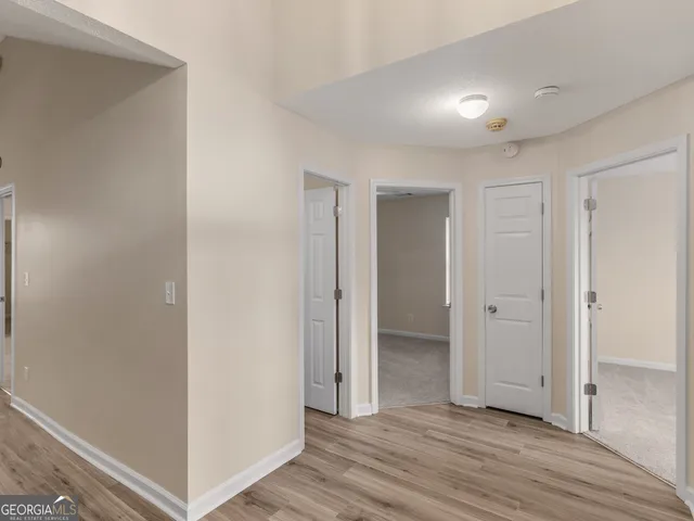 a view of a hallway with wooden floor