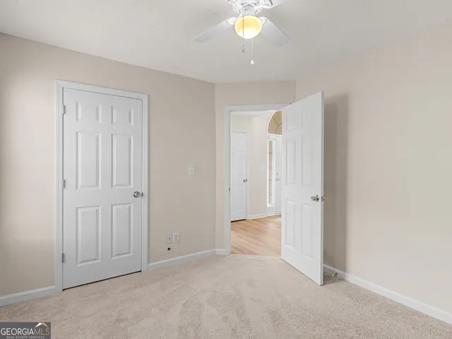 an empty room with closet area