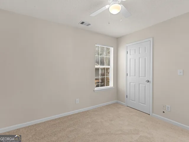 an empty room with windows and closet