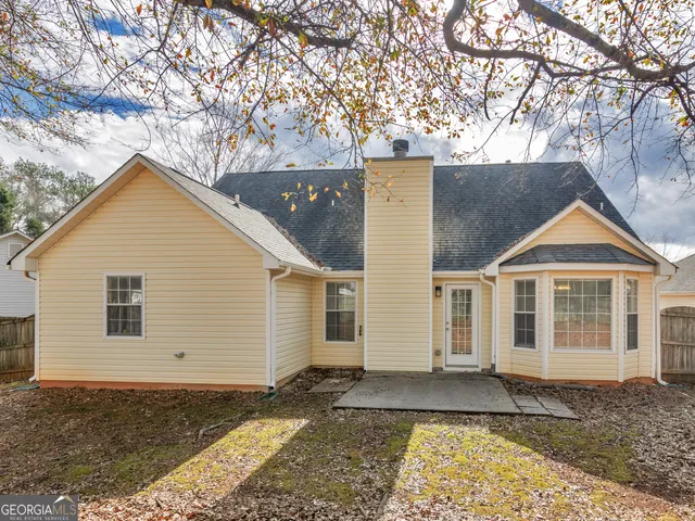a view of a grey house with a yard