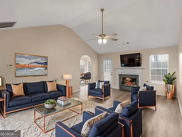 a living room with furniture fireplace and a flat screen tv