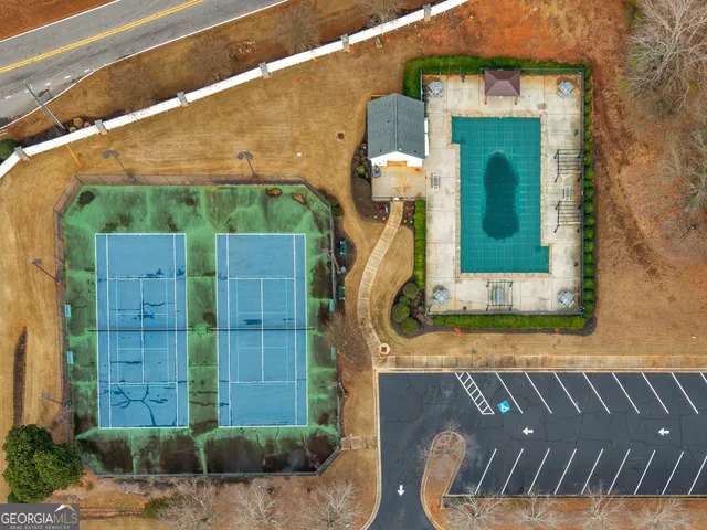 a view of a small house with brick wall and potted plants