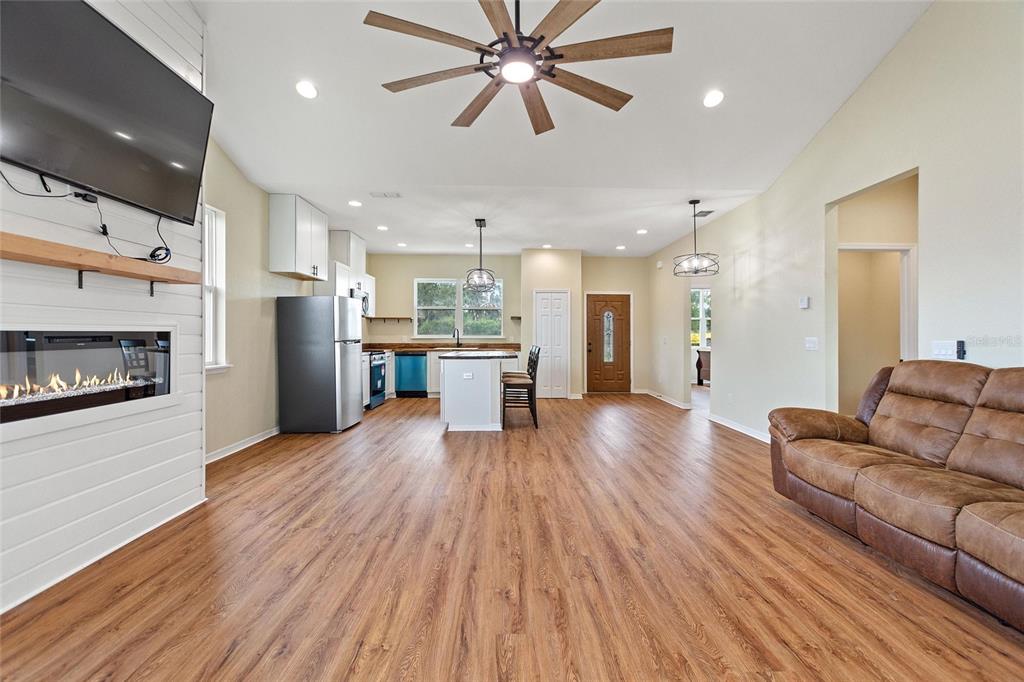 1042 Golden Bough Road Lake Wales, FL 33898 - Photo 16 of 53 a living room with stainless steel appliances kitchen island hardwood floor and a kitchen view
