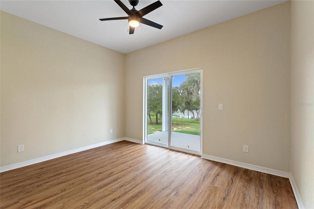 1042 Golden Bough Road Lake Wales, FL 33898 - Photo 22 of 53 a view of a big room with wooden floor and windows