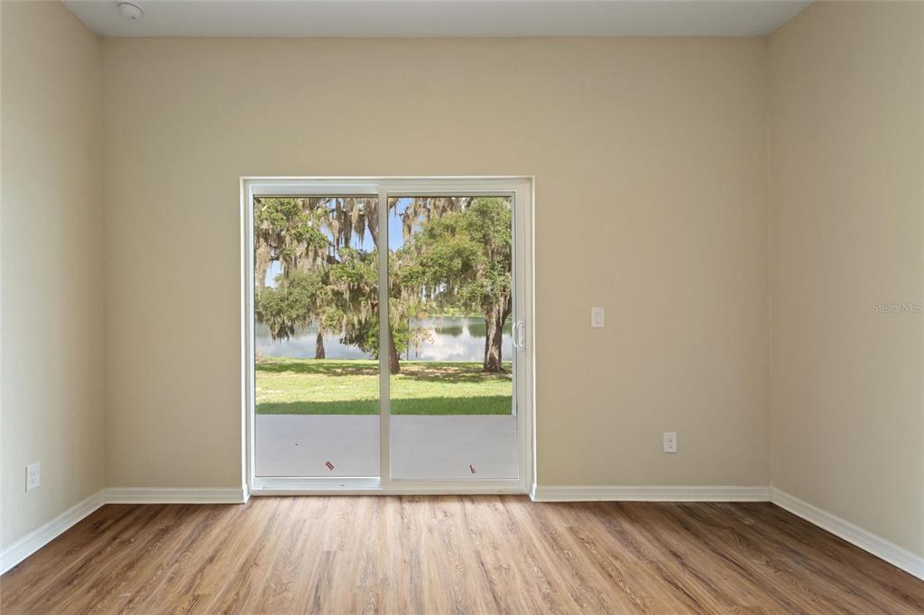 1042 Golden Bough Road Lake Wales, FL 33898 - Photo 24 of 53 a view of a room with wooden floor and a window