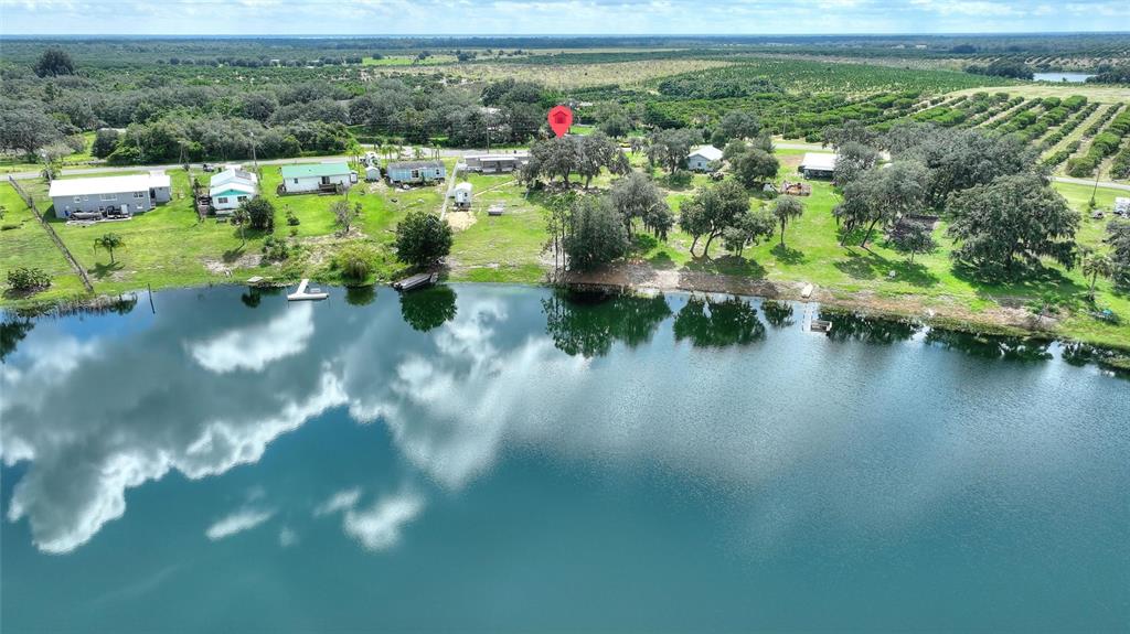 1042 Golden Bough Road Lake Wales, FL 33898 - Photo 34 of 53 a view of a lake with a house