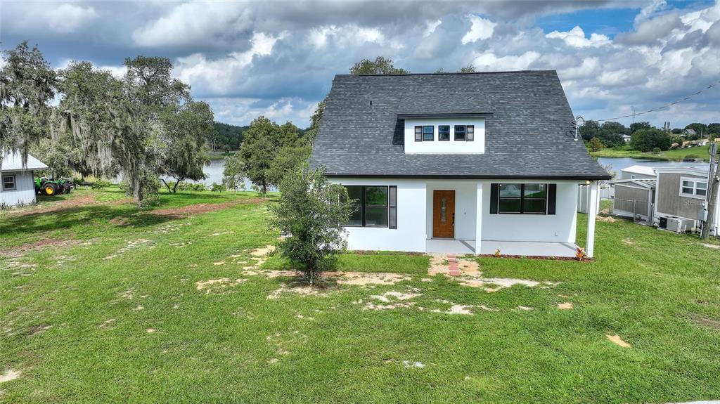 1042 Golden Bough Road Lake Wales, FL 33898 - Photo 41 of 53 a front view of a house with a yard