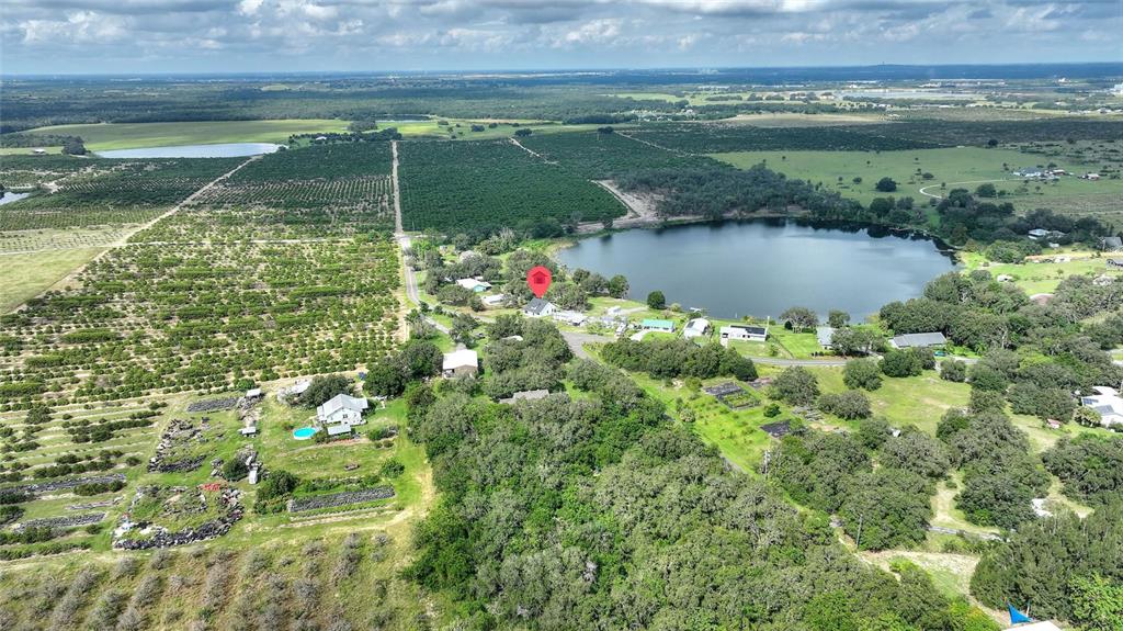 1042 Golden Bough Road Lake Wales, FL 33898 - Photo 48 of 53 a view of a lake with a house in the background