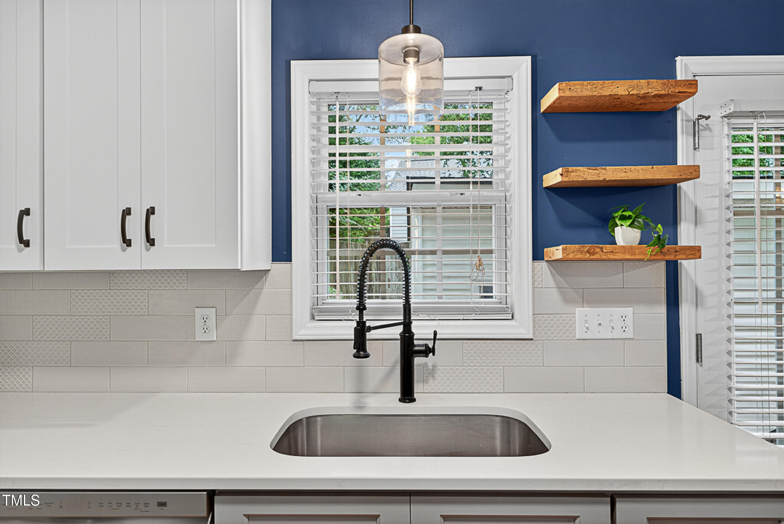 2407 Trout Stream Drive Raleigh, NC 27604 - Photo 11 of 26 a kitchen with a sink and a large window