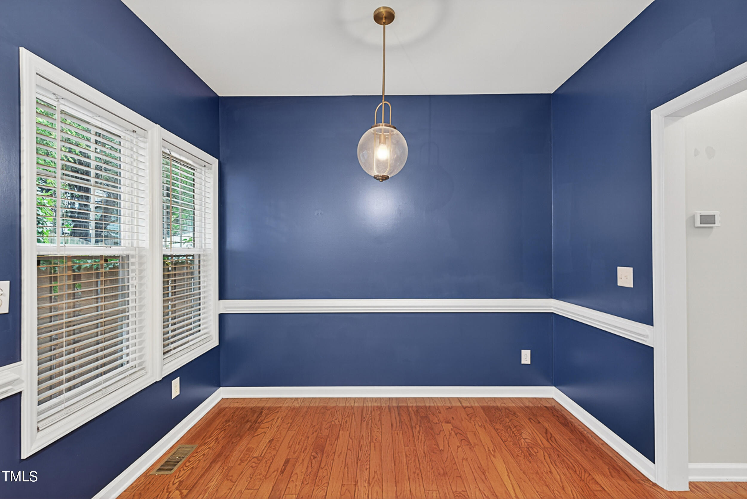 2407 Trout Stream Drive Raleigh, NC 27604 - Photo 13 of 26 a view of wooden floor in an empty room with a window