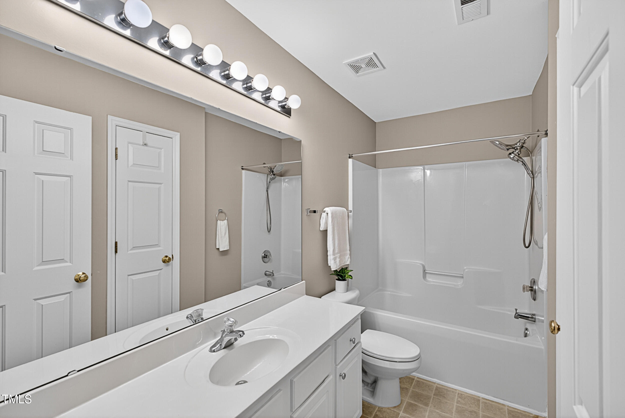 2407 Trout Stream Drive Raleigh, NC 27604 - Photo 21 of 26 a bathroom with a sink a toilet and shower