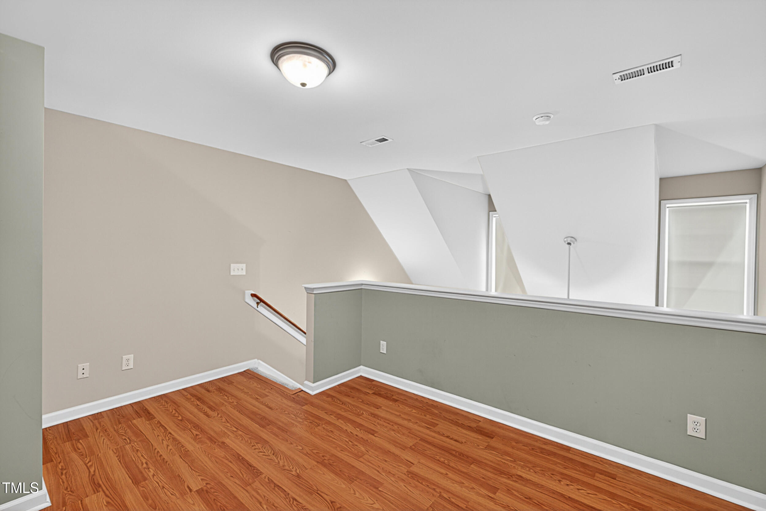 2407 Trout Stream Drive Raleigh, NC 27604 - Photo 22 of 26 a view of a room with wooden floor and fan