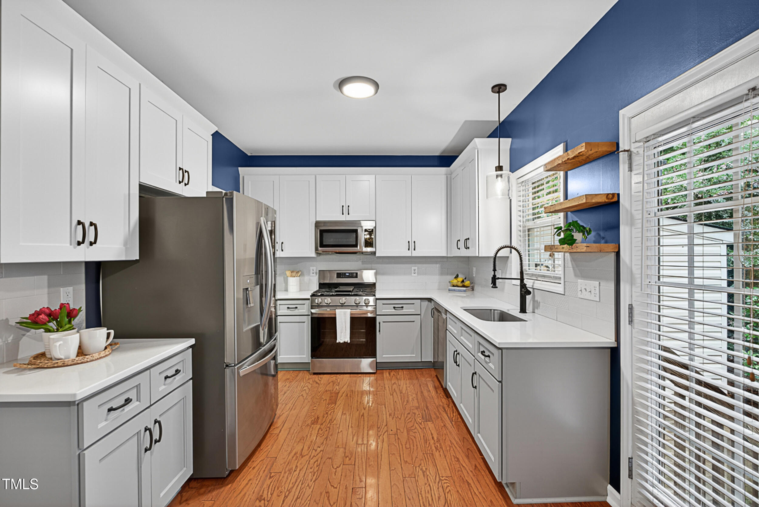 2407 Trout Stream Drive Raleigh, NC 27604 - Photo 10 of 26 a kitchen with stainless steel appliances granite countertop a refrigerator a sink dishwasher a oven with white cabinets and wooden floor