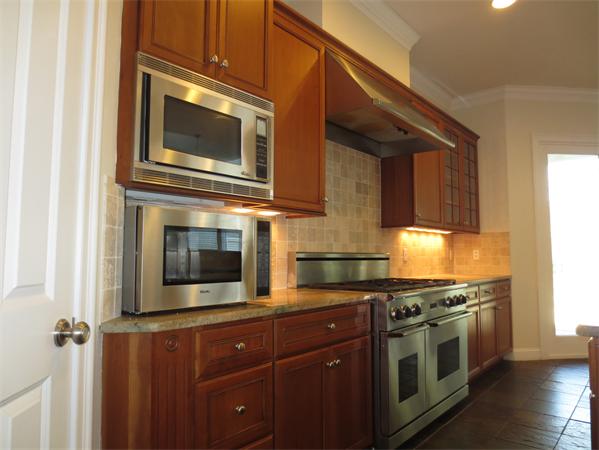 36 Open Space Drive Sandwich, MA 02563 - Photo 16 of 30 a kitchen with stainless steel appliances granite countertop a stove and a microwave