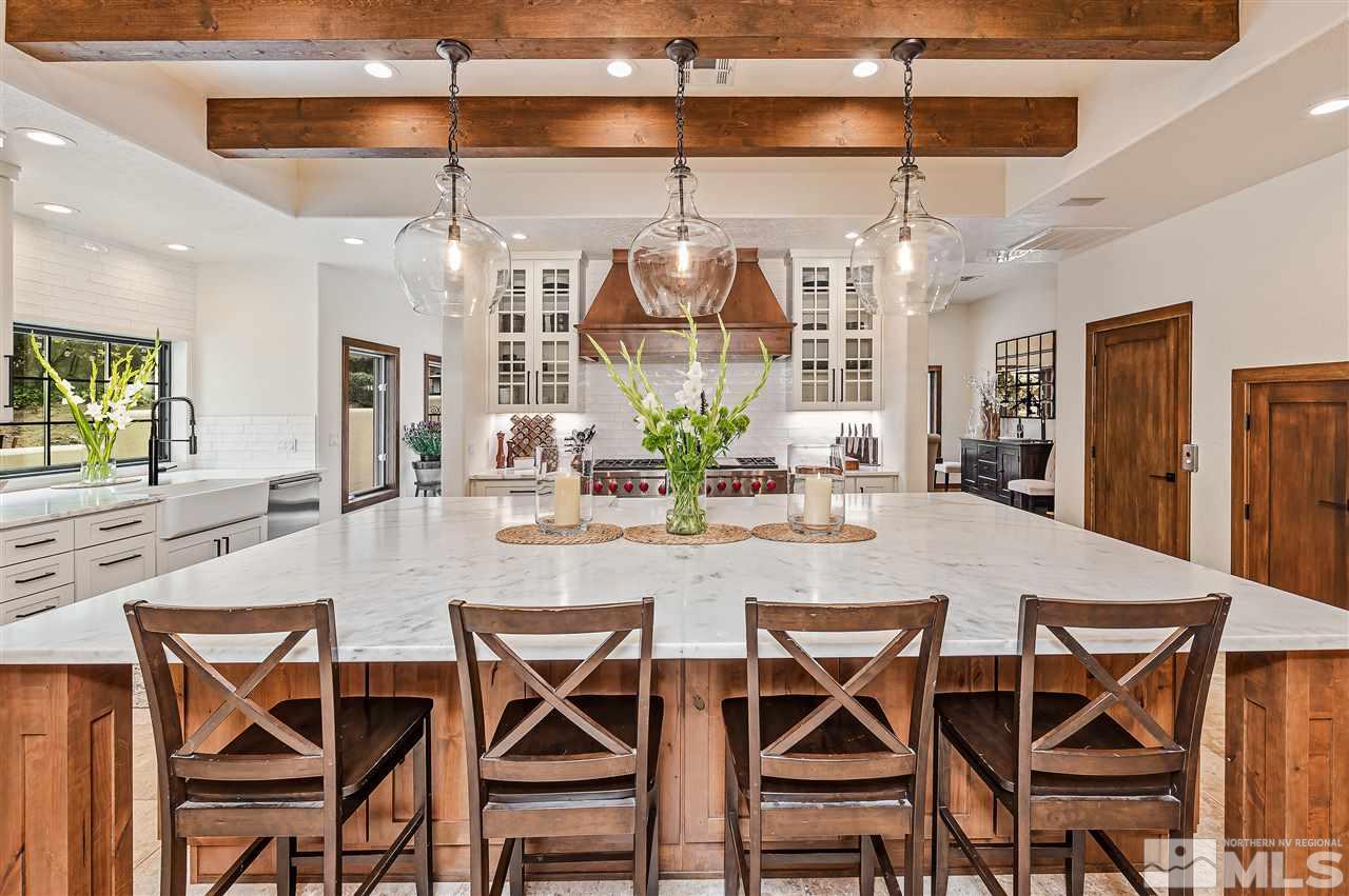 110 Sawbuck Road Reno, NV 89519 - Photo 11 of 40 a dining room with wooden floor a chandelier a glass table and chairs