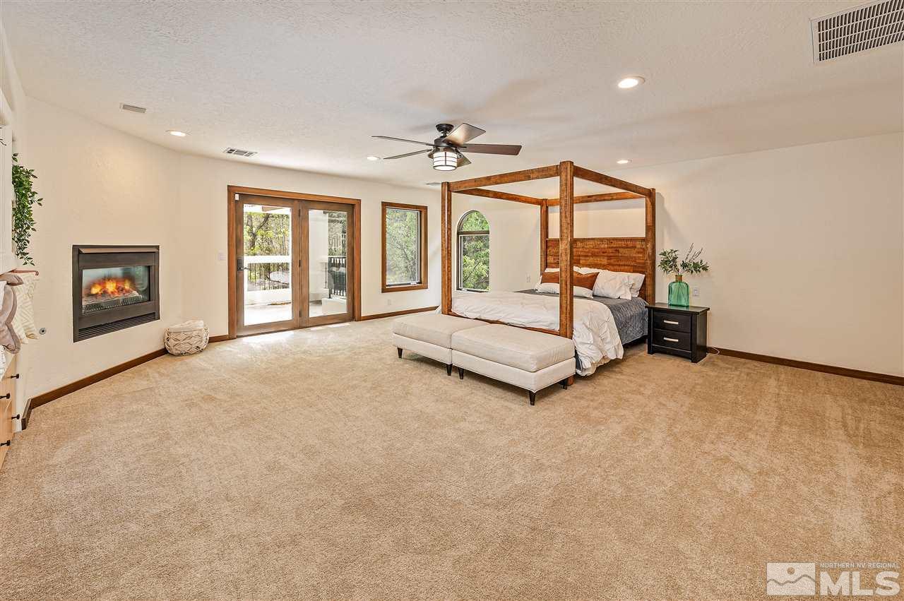 110 Sawbuck Road Reno, NV 89519 - Photo 23 of 40 a spacious bedroom with a bed and a flat screen tv