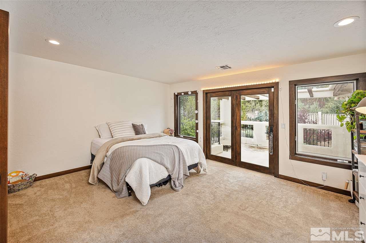 110 Sawbuck Road Reno, NV 89519 - Photo 27 of 40 a spacious bedroom with a bed and large window