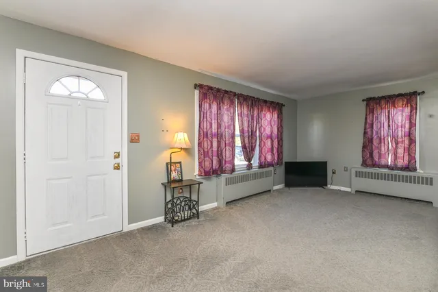 a view of a room with furniture and window