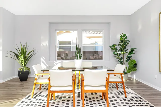 a dining room with furniture and wooden floor