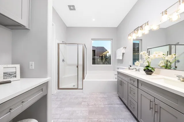a spacious bathroom with a tub sink and mirror