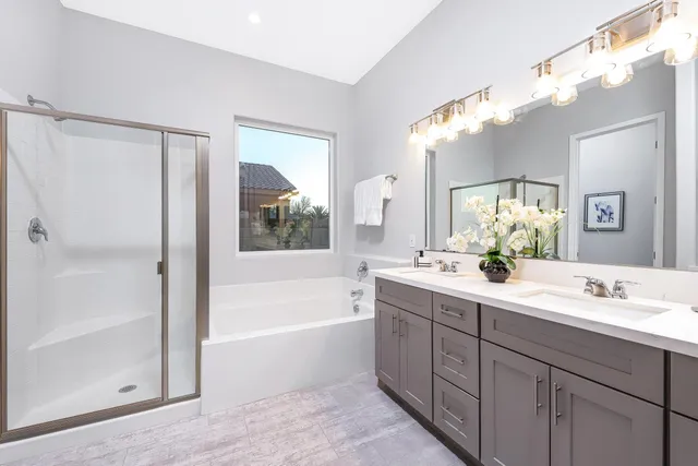 a bathroom with a tub a sink and mirror